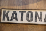 Distressed black 'Katonah' lettering on the vintage style wood framed sign.