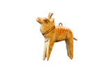Vintage wooden deer ornament, hand-painted in light brown with stylized markings.