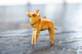 Hand-painted eye and strap details on the vintage wooden deer ornament's head.