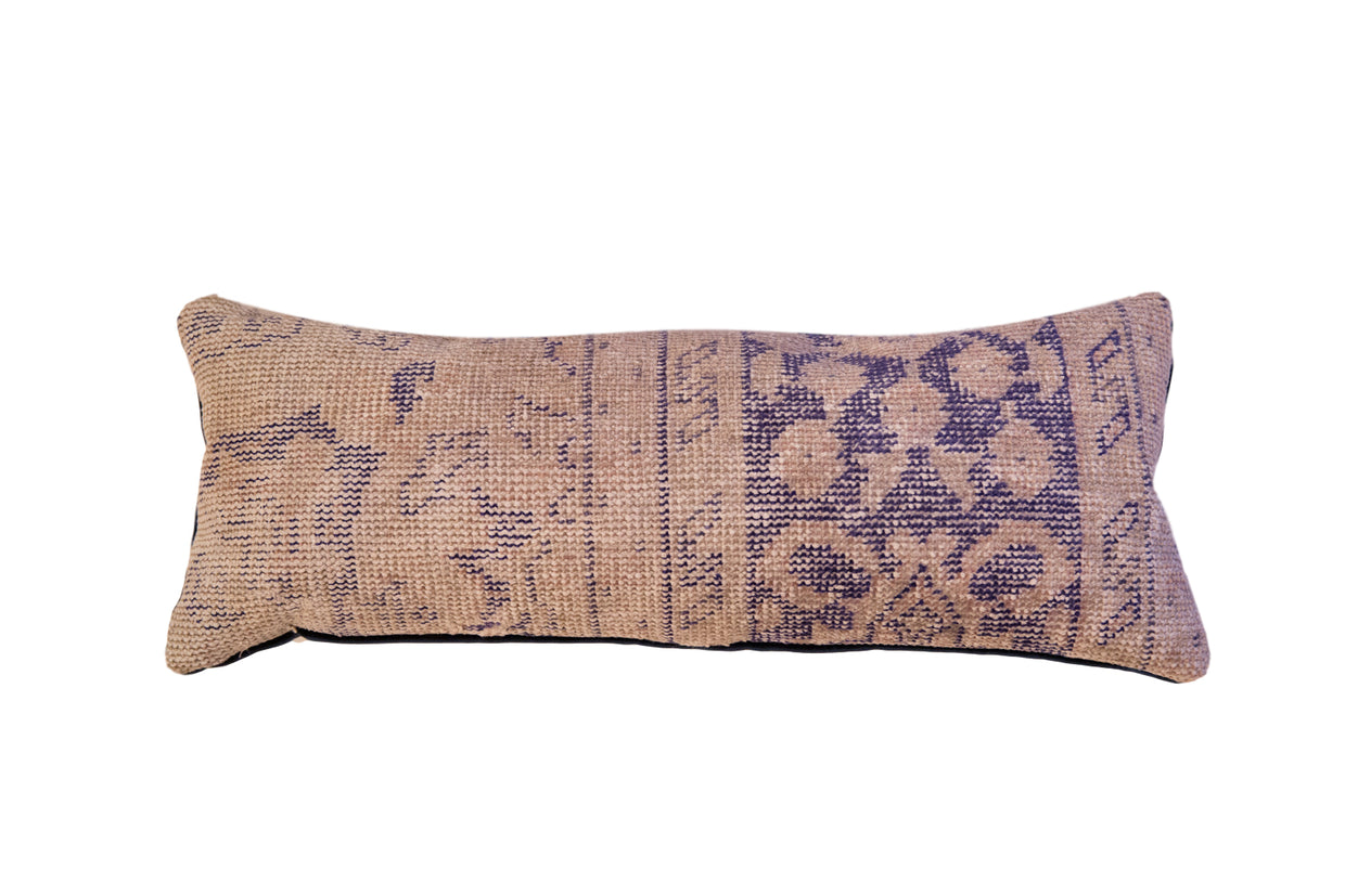 Reclaimed vintage Turkish rug fragment pillow with faded beige and dark blue geometric pattern.