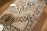 Rusty and painted accordion arms of an antique fleur de lis shaving mirror.