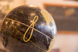Black 1950s Cram's globe with yellow Analemma figure and geographic text.