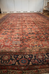 Vintage Mahal carpet's navy border with palmette and floral vinery on cherry red field.