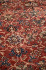 Vintage Persian Mahal carpet's time-softened pile with cherry red, navy blue palmettes, and floral vinery.