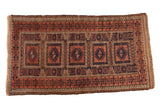 Antique Persian Belouch rug, multi-panel geometric medallions, madder root, navy blue, dark chocolate.