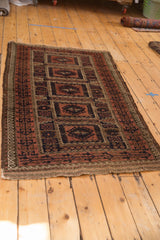 Antique Belouch rug corner with germinating plant motif border, madder root geometrics, light tatter.