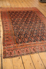 Antique Malayer rug's vibrant fuschia raspberry border and navy allover boteh field.