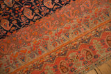 Antique Malayer rug detail: fuschia raspberry border, green paisley motifs, navy boteh field, abrashes.