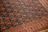 Abrashed allover boteh pattern in fuschia and navy, showcasing a border and storied edge.