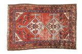 Vintage Hamadan rug with geometric double medallion, red, navy, ivory, Herati field, worn patina.