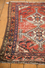 Vintage Hamadan rug: geometric stepped contour and Herati motif in red, navy, ivory, showing wear.