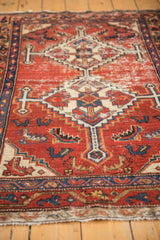 Worn cherry red field of vintage Hamadan rug, geometric Herati motif, navy and ivory accents.