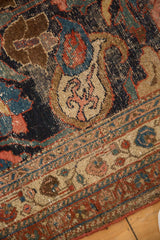 Antique Kurdish Bijar rug, showing nuanced oversized motifs in navy, blush, and beige with even wear to knot heads.