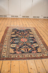 Detailed corner of antique Kurdish Bijar rug, highlighting intricate borders and visible pile wear.