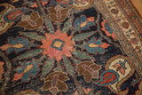 Antique Kurdish Bijar rug detail: blush, mallard green, and navy oversized pattern, showing pile wear.
