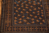 Corner of antique Belouch rug, terracotta and navy botehs, geometric borders, tattered side.