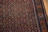 Antique Belouch rug with navy, terra cotta repeating trellis pattern and detailed geometric border.