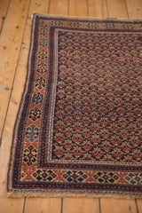 Antique hand-knotted Belouch rug corner: trellis floral field, colorful geometric border.