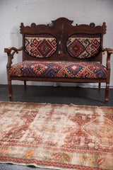 Upper field of antique Caucasian rug, displaying extensive threadbare areas and geometric patterns.
