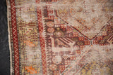 Antique Caucasian rug's worn zigzag border and threadbare antique ivory field.