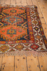 Visible tatter on the fringe and geometric border of the vintage Caucasian rug.