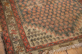 Antique Caucasian rug border and lightning serrated spandrel with worn orange and teal.