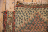 Hard wear and exposed foundation on antique Caucasian rug's lightning serrated corner spandrel.