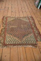 Antique Caucasian rug displaying significant wear, frayed edges, and exposed foundation.