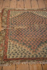 Antique Caucasian rug's tattered fringe and worn perimeter, revealing serrated lightning motifs.