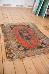 Hard tatter and splits on the perimeter of a geometric vintage Caucasian rug.