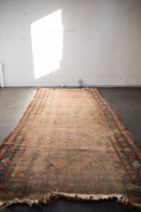 Antique Lilihan runner, pale dusty raspberry field, blue borders, mostly even wear, tattered ends.