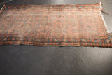 Worn antique Lilihan runner - geometric border in blue and raspberry, with tattered end.