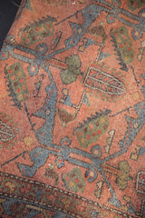 Antique Lilihan rug texture with pale dusty raspberry, sky blue serrated leaves.
