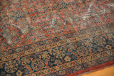 Vintage Mahal carpet's traditional paneled henna motif in madder root red and navy, with notable wear.