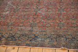 Vintage Mahal rug: madder root red field, navy border, henna motif, visible wear, tattered end.