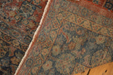 Vintage Mahal carpet detail with worn henna plan pattern, revealing foundation, and tattered fringe.