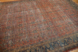 Detailed corner view of a Vintage Mahal carpet, showcasing navy blue border with madder red field and surface wear.