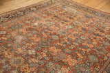 Chestnut brown rust Mahal carpet's allover floral pattern and visible pile wear.