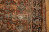 Vintage Mahal carpet with chestnut brown rust floral field, navy samovar border, and wear.