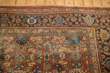 Corner detail of vintage Mahal carpet showing samovar border, floral motifs, chestnut rust, navy blue, and wear.
