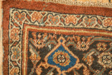 Corner of Vintage Mahal carpet, chestnut rust samovar border with some foundation visible.