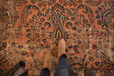 Dusty rose antique Lilihan carpet with navy floral sprays and visible knot wear.