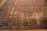 Antique Lilihan carpet's dusty rose field, navy blue floral elements, and visible wear to knot heads.