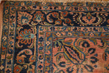 Storied texture of a Persian Antique Lilihan corner, showing dusty rose and navy floral borders.
