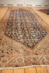 Vintage Hamadan runner corner, geometric starburst design in navy, copper, and sand, with fringe.