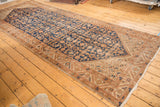 Vintage Hamadan runner corner detail with Herati motif, starburst spandrel, and ivory fringe.