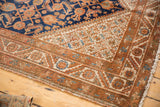 Vintage Hamadan rug corner: unusual starburst spandrel, madder root borders, and navy Herati field.