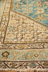 Corner detail of vintage distressed Persian Hamadan rug with low pile and aqua, ivory Herati motif.