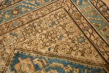Distressed low pile Herati motif with aqua, antique ivory, and chocolate brown.