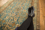 Decorative distressed aqua blue Herati pattern on vintage Hamadan runner, with boots.